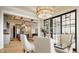 Dining room showcasing table with seating, lighting fixtures, with a partial view of the kitchen and living room at 15600 Woodford Dr, Westfield, IN 46074