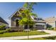 Charming two-story home with a well-manicured front lawn, and a gray exterior with wood accents at 15600 Woodford Dr, Westfield, IN 46074