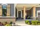 Inviting front porch with wooden pillars, brick accents, and a cozy seating area at 15600 Woodford Dr, Westfield, IN 46074