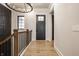 Bright hallway with hardwood floors, iron railing, and neutral wall colors at 15600 Woodford Dr, Westfield, IN 46074