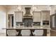 Well-lit kitchen with seating at the island, stainless steel appliances and pendant lights at 15600 Woodford Dr, Westfield, IN 46074