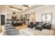Open concept living room with hardwood floors, kitchen with island, and comfortable gray upholstered furniture at 15600 Woodford Dr, Westfield, IN 46074
