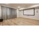 Basement media room with a projector screen, sound system, and large window with curtains at 15600 Woodford Dr, Westfield, IN 46074
