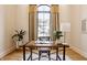 Bright home office featuring a wooden desk, modern chair, hardwood floors, and natural light from the window at 15600 Woodford Dr, Westfield, IN 46074