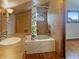 Tile bathroom featuring wood cabinets, accent lighting, and a tub-shower at 1602 California St, Columbus, IN 47201