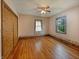 Bedroom featuring hardwood floors, a closet, and dual windows providing ample natural light at 1602 California St, Columbus, IN 47201