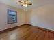 A cozy bedroom featuring hardwood floors, a ceiling fan, and a window with natural light at 1602 California St, Columbus, IN 47201