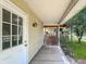 Inviting covered front porch and main entry featuring brick steps and view to a second porch at 1602 California St, Columbus, IN 47201