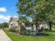 Charming home with a landscaped front yard and mature trees on a sunny day at 1602 California St, Columbus, IN 47201