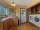 Bright kitchen area with washer and dryer, hardwood floors, and modern appliances at 1602 California St, Columbus, IN 47201