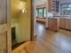 Stairway leading to kitchen area with wood cabinets and window with natural light at 1602 California St, Columbus, IN 47201