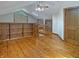 Large living room with hardwood floors, vaulted ceiling, built-in shelves, and ample natural light at 1602 California St, Columbus, IN 47201