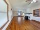 Open-concept living room featuring hardwood floors and a white brick fireplace at 1602 California St, Columbus, IN 47201