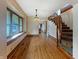 Open living area featuring hardwood floors and a staircase, bathed in natural light at 1602 California St, Columbus, IN 47201
