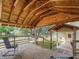 Covered wooden porch with a comfortable seating area and backyard views at 1602 California St, Columbus, IN 47201
