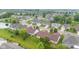 An aerial view of a lush residential neighborhood featuring well-maintained lawns and mature trees at 1605 Leisure Way, Greenfield, IN 46140