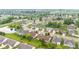 Serene aerial view of a neighborhood with well-maintained lawns and a community pond at 1605 Leisure Way, Greenfield, IN 46140