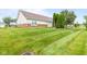 Backyard showcasing a well maintained lawn at 1605 Leisure Way, Greenfield, IN 46140