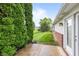 View of the backyard from the patio with mature evergreens at 1605 Leisure Way, Greenfield, IN 46140