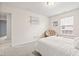 Bright bedroom with neutral walls, a comfortable bed, and a cozy papasan chair near the window at 1605 Leisure Way, Greenfield, IN 46140