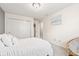 Bright bedroom featuring a comfortable bed, closet with sliding doors, and a cozy papasan chair near the window at 1605 Leisure Way, Greenfield, IN 46140