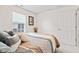 Comfortable bedroom featuring a bed with stylish linens, window, and a white door at 1605 Leisure Way, Greenfield, IN 46140
