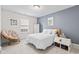 Cozy bedroom with a soothing color palette, a comfortable bed, and a charming papasan chair near the window at 1605 Leisure Way, Greenfield, IN 46140
