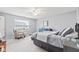Comfortable bedroom featuring a bed with stylish linens, window with blinds, and a cozy chair at 1605 Leisure Way, Greenfield, IN 46140