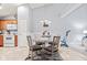 Dining area with glass table and four chairs next to oak cabinets and white appliances at 1605 Leisure Way, Greenfield, IN 46140