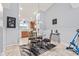 Cozy dining area featuring a glass-top table, four chairs, and a partial view of the adjoining kitchen and decor at 1605 Leisure Way, Greenfield, IN 46140