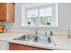 Kitchen sink beneath window with plants and bright natural light at 1605 Leisure Way, Greenfield, IN 46140