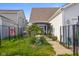 Fenced backyard with patio, garden area, and walkway to the home, providing privacy and space at 2017 Shadow Creek Blvd, Columbus, IN 47201