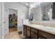 Bathroom with double sinks, lots of storage, and view into walk-in closet and glass shower at 2017 Shadow Creek Blvd, Columbus, IN 47201
