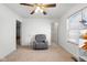A bedroom with a cozy recliner, ceiling fan, and ample natural light at 2017 Shadow Creek Blvd, Columbus, IN 47201