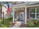 Attractive brick home with rocking chairs on the covered front porch and tidy landscaping at 2017 Shadow Creek Blvd, Columbus, IN 47201