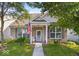 Charming brick home with covered porch, manicured lawn, and American flag at 2017 Shadow Creek Blvd, Columbus, IN 47201