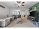 Cozy living room features a ceiling fan, comfortable seating, and a unique wooden coffee table at 2017 Shadow Creek Blvd, Columbus, IN 47201
