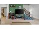 Living room featuring a TV, a staircase, and modern decor at 2017 Shadow Creek Blvd, Columbus, IN 47201