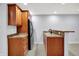 Basement wet bar area featuring wood cabinets, granite countertops, and a sink at 2263 Glebe St, Carmel, IN 46032
