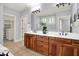 Bathroom features a double vanity with wood cabinets and tile floor at 2263 Glebe St, Carmel, IN 46032