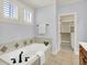Bathroom with a white tub with black hardware at 2263 Glebe St, Carmel, IN 46032