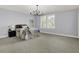 Light-filled bedroom featuring plush carpeting and a stylish black chandelier at 2263 Glebe St, Carmel, IN 46032