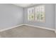 Bedroom showcasing neutral walls and carpet and a large window with white shutters at 2263 Glebe St, Carmel, IN 46032