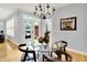 Cozy dining area with a glass table, stylish chandelier, and views to the outdoor patio at 2263 Glebe St, Carmel, IN 46032