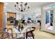 Open-concept dining and living area with hardwood floors and natural light creates inviting atmosphere at 2263 Glebe St, Carmel, IN 46032