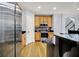 Bright kitchen with stainless steel appliances, wood cabinets, and beautiful hardwood flooring at 2263 Glebe St, Carmel, IN 46032