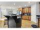 Open-concept kitchen with stainless steel appliances, center island, and seamlessly connects to the dining area at 2263 Glebe St, Carmel, IN 46032