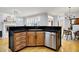 Spacious kitchen island features a sink, dishwasher, and stylish wood cabinets with hardware at 2263 Glebe St, Carmel, IN 46032