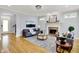 Spacious living room features hardwood floors, a fireplace, an area rug, and comfortable seating near a large window at 2263 Glebe St, Carmel, IN 46032