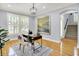 Bright home office featuring hardwood floors, a stylish desk, a large window, and modern decor at 2263 Glebe St, Carmel, IN 46032